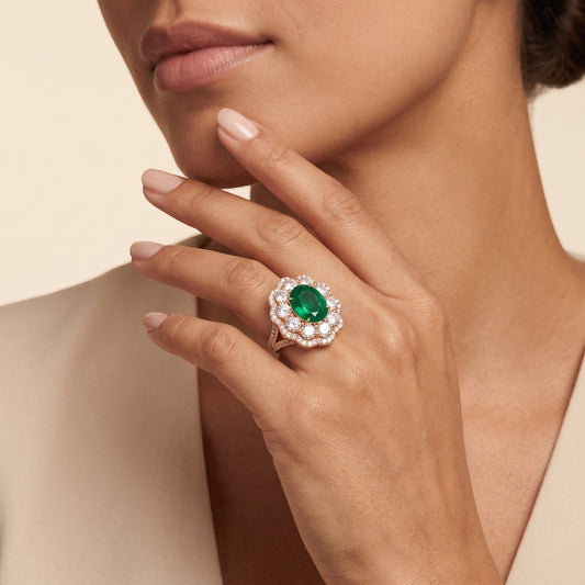 BH Diamond Center rose gold ring featuring a large oval emerald surrounded by a halo of round lab-grown diamonds